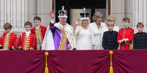 King Charles III and Queen Camilla wave to the crowds from the balcony of Buckingham Palace.