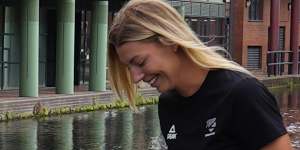 New Zealand beach volleyball players try to fish their ball out of a Birmingham canal during a photoshoot.