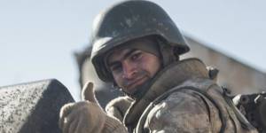 A Turkish soldier on a tank is pictured in the northern Syrian town of Kobane as he returns from a military operation inside Syria.