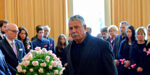 George Halvagis,father of Mersina,touches the coffin of Doncaster teenager Masa Vukotic at her funeral.