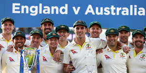 Australia with the Ashes trophy:muted celebration.