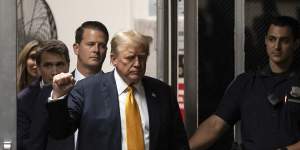 Former president Donald Trump gestures as he walks to the courtroom during his hush money trial at Manhattan criminal court.