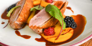 Hay-smoked duck breast with carrot puree and berries.