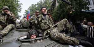 Pro-Russian gunmen atop an armored personal carrier shout slogans during a Victory Day celebration,which commemorates the 1945 defeat of Nazi Germany,in Slovyansk,eastern Ukraine.