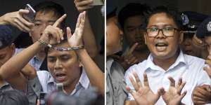 Reuters journalists Kyaw Soe Oo,left,and Wa Lone are handcuffed as they are escorted by police out of a court in Yangon,Myanmar,last year.