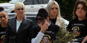 A grandmother of Nathan Reynolds,Toni Reynolds (3rd from left) wipes tears from her eyes during a statement on Nathan’s death in custody in 2018.