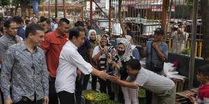 Chris Barrett,left,joined Indonesian President Joko Widodo for a tour of Palmerah market in Jakarta last year before interviewing him at the Merdeka Palace.