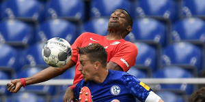 Schalke's Bastian Oczipka (front) competes with Augsburg's Felix Uduokhai during the Miners'3-0 Bundesliga loss on Sunday.