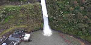 The Thomson Dam spills over in October 2022.