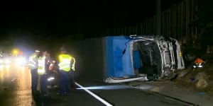 A driver was freed after a truck rolled on its side on its motorway,but another man died at a crash scene 50 metres down the road.