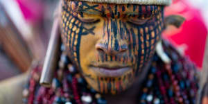 A member of an indigenous community joins a demonstration for indigenous land rights in Brasilia,Brazil,on Wednesday. 