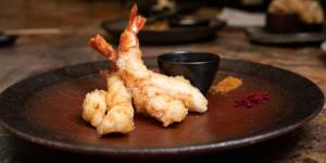 Tempura king prawns are served with a little bowl of dashi soy and two fine-grained salts for dipping.