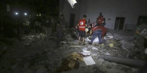 Libyan Red Crescent workers recover migrants bodies after an airstrike at a detention centre in Tajoura,east of Tripoli.