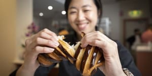 Frances Song breaks open a chocolate croissant at Layers Sydney in St Leonards.