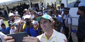 Pat Cummins takes a selfie with fans after Australia’s Galle victory.