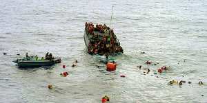 Australian navy personnel rescue asylum-seekers from a sinking boat off Christmas Island in October 2001. Witness BR2 was not part of this crew. 