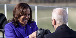 US Vice President Kamala Harris bumps fists with President Joe Biden after she was sworn in during the inauguration in January.