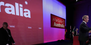 A protester is dragged off stage by security at Labor's national conference in Adelaide.
