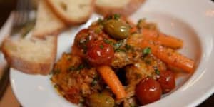 Braised rabbit with cherry tomatoes,carrots and olives.