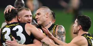 Kamdyn McIntosh,Josh Caddy and Dustin Martin celebrates a goal.