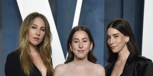 Este Haim,from left,Alana Haim,and Danielle Haim arrive at the Vanity Fair Oscar Party in 2022.