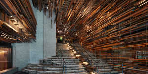 The grand staircase,composed of a frenzy of horizontal strips of recycled,rough-hewn timber.