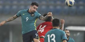 Australia’s Jamie Maclaren gets his head on the ball against Nepal in Kuwait earlier this year.