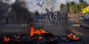 Demonstrators block a road during a protest demanding the immediate release of hostages.