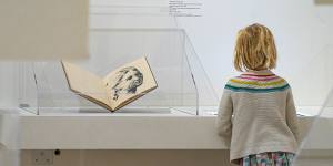A girl observes part of the Picasso:14 Sketchbooks exhibit at Pace Gallery in New York.