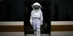 A man dressed as an astronaut steps off a train in Istanbul,Turkey,as part of a campaign to promote a NASA Space Exhibition in December.