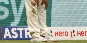 Usman Khawaja after he injured his leg in the field.