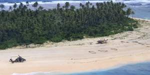 An Australian Army helicopter lands on Pikelot Island in the Federated States of Micronesia,where three men were found on Sunday after missing for three days.