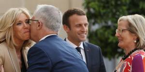 Malcolm Turnbull kisses Brigitte Macron,wife of French President Emmanuel Macron on arrival at the Palace.