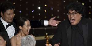 Bong Joon Ho (right) is presented with the award for best picture for Parasite from presenter Jane Fonda.