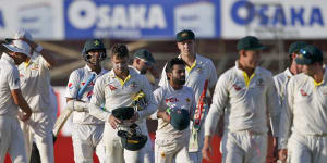 Pakistani and Australian players leave the ground at the end of the play of the second test match between Pakistan and Australia.