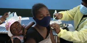 A baby cries as her mother receives her Pfizer vaccine against COVID-19,in Diepsloot Township near Johannesburg. A new COVID-19 variant has been detected in South Africa.