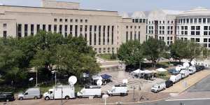 Television news crews set up outside federal court in Washington.