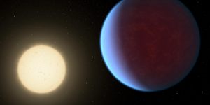 This illustration provided by NASA in 2017 depicts planet 55 Cancri e,right,orbiting its star. The new James Webb Telescope has allowed researchers to see a thick atmosphere around the planet that is about 41 light years away.