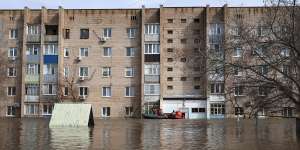 Russian Emergency Ministry employees ride a boat along a flooded street in Orenburg,Russia.