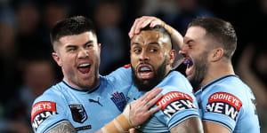 Josh Addo-Carr celebrates a try with James Tedesco and Bradman Best.