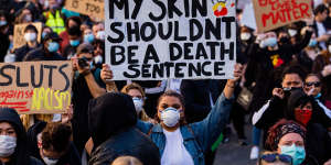 Signs included"my skin shouldn't be a death sentence".