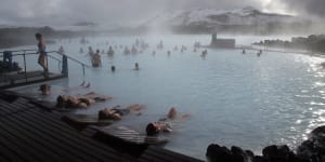 Guests relax in geothermal seawater in the main lagoon at the Blue Lagoon spa in Grindavik,Iceland,