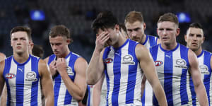 Dejected North Melbourne players after their big loss to Hawthorn.