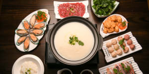 Shunde-style porridge base hotpot with seafood,sliced beef and delicate fish and pork balls. 