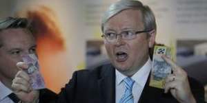 Prime Minister Kevin Rudd displays a $5 and $50 note to make a point during a press conference at the the Children's Medical Research Institute in Westmead,Sydney on Sunday 18 August 2013. Election 2013. Photo:Andrew Meares