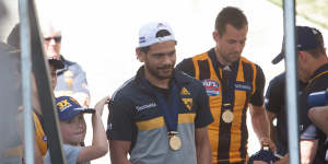 Cyril Rioli and Luke Hodge after the 2015 premiership win.