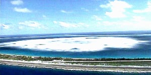 The sea close to the shore of Fangataufa Atoll turns white following the detonation of an underground French nuclear test in 1995. 