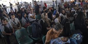 Families waiting to cross into Egypt at the Rafah crossing.