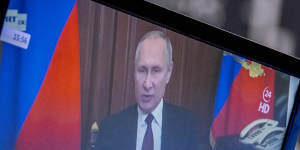 Russia’s President Vladimir Putin appears on a television screen at the stock market in Frankfurt,Germany on Friday.