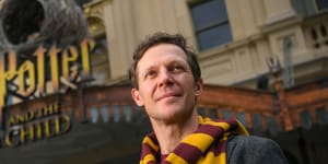 Actor Gareth Reeves in his Harry Potter scarf in front of the Princess Theatre.